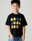 Front view of a boy wearing the Chaser Spooky Friends Boys Tee on a neutral background with baggy bluejeans