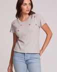 Front view of a woman wearing the Chaser Star Setter Cropped Tee on a neutral background