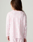 Back view of a girl wearing the Chaser Stars Allover Girls Tee on a neutral background with top