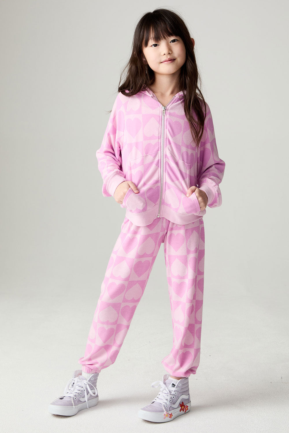 A full body front view of a girl wearing the Chaser Straight To The Heart Girls Hoodie on a neutral background