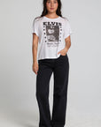 A full body front view of a woman wearing the Chaser Sun Records Elvis 1972 Tee on a neutral background 