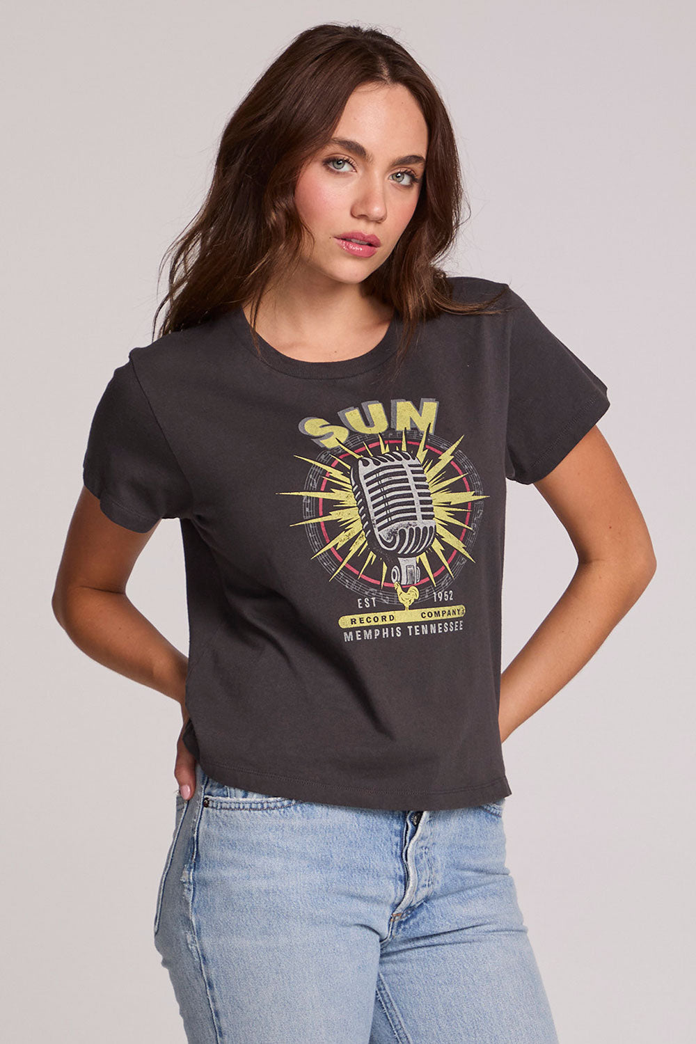 A full body front view of a woman wearing the Chaser Sun Records Tee on a neutral background