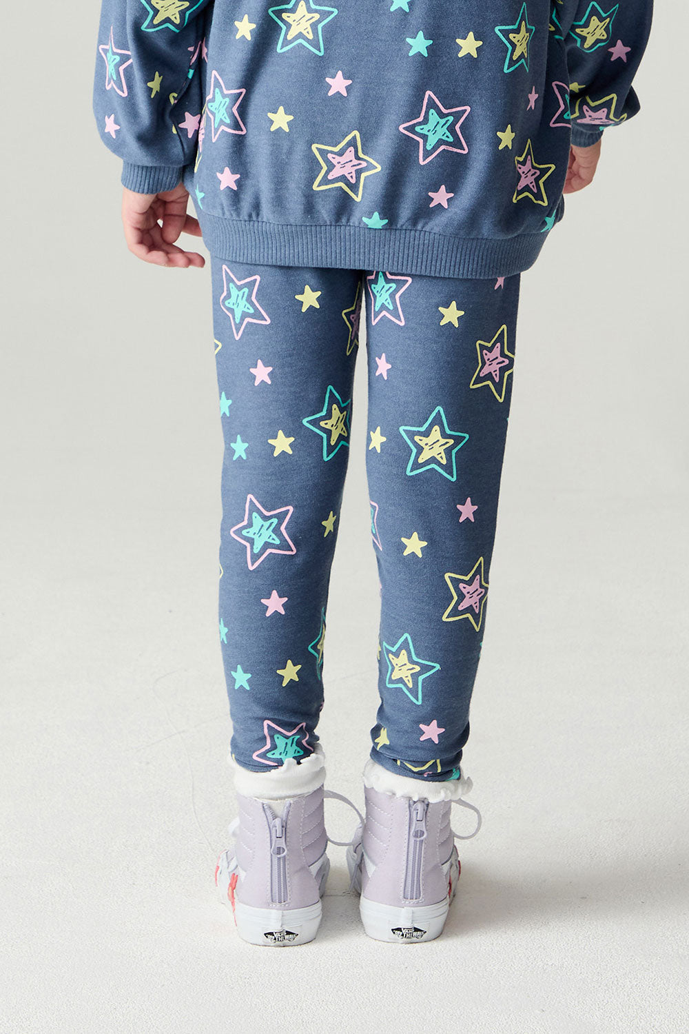 Back view of a girl wearing the Chaser Super Star Girls Joggers on a neutral background