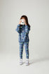 Front view of a girl wearing the Chaser Super Star Girls Zip Up on a neutral background holding a camera