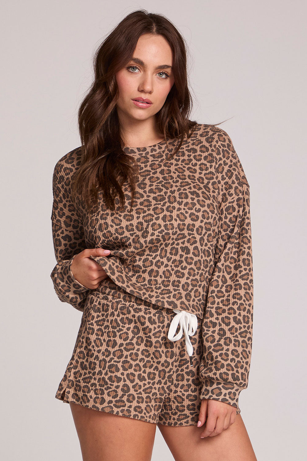 Front view of a woman wearing the Chaser Suzzans Leopard Sweatshirt on a neutral background