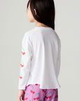 Back view of a girl wearing the Chaser Sweethearts Girls Tee on a neutral background with pants