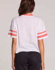 Back view of a woman wearing the Chaser Teddy Tee on a neutral background and pants
