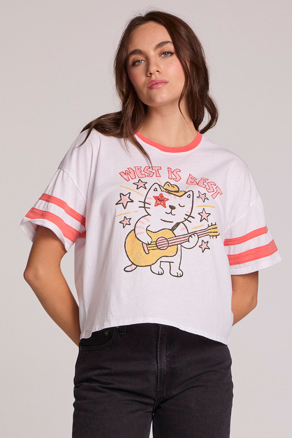 Front view of a woman wearing the cropped Chaser Teddy Tee on a neutral background and black pants