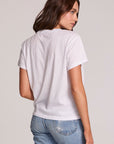 Back view of a woman wearing the Chaser  The Best Cropped Graphic Tee and blue jeans on a neutral background