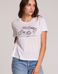 Front view of a woman wearing the Chaser  The Best Cropped Graphic Tee on a neutral background