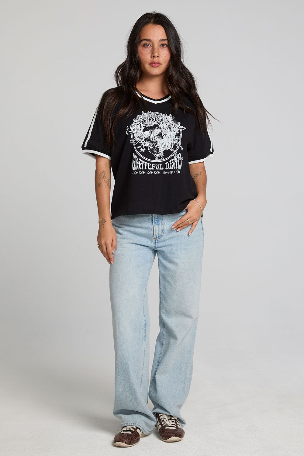 A full body front view of a woman wearing the Chaser The Grateful Dead Winterland Area Tee on a neutral background