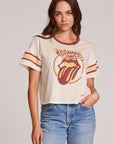 Front view of a woman wearing the Chaser  The Rolling Stones Retro Tongue Tee on a neutral background with jeans and hand in pocket