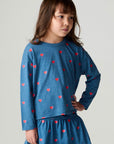 Front view of a girl wearing the Chaser Tiny Hearts Girls Tee on a neutral background with arms at sides