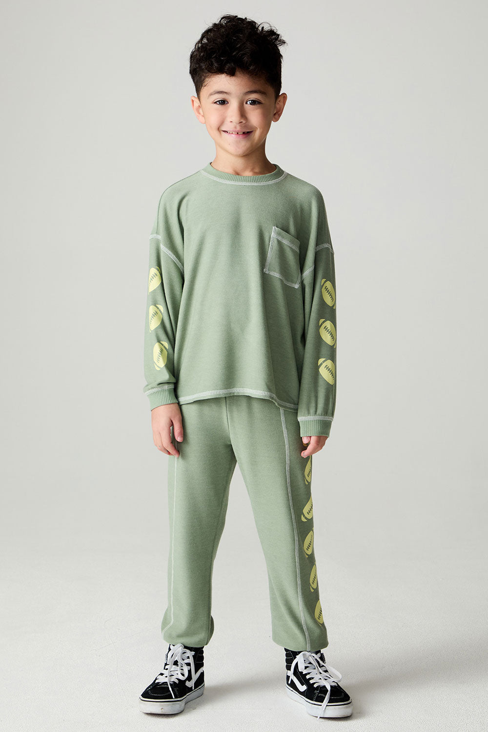 A full body front view of a boy wearing the Chaser Touchdown Boys Tee on a neutral background