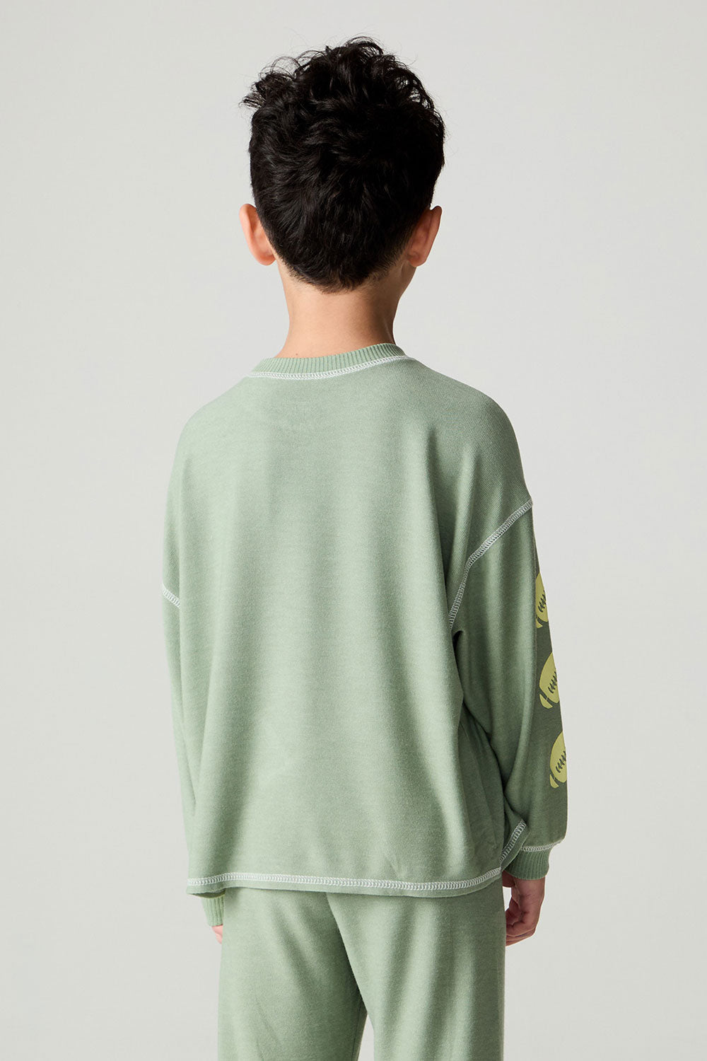 Back front view of a boy wearing the Chaser Touchdown Boys Tee on a neutral background with shirt