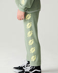 Side view of a boy wearing the Chaser Touchdown Pants Boys Jogger on a neutral background and shirt