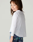 Back view of a girl wearing the Chaser Under The Stars Girls Tee on a neutral background looking over one shoulder
