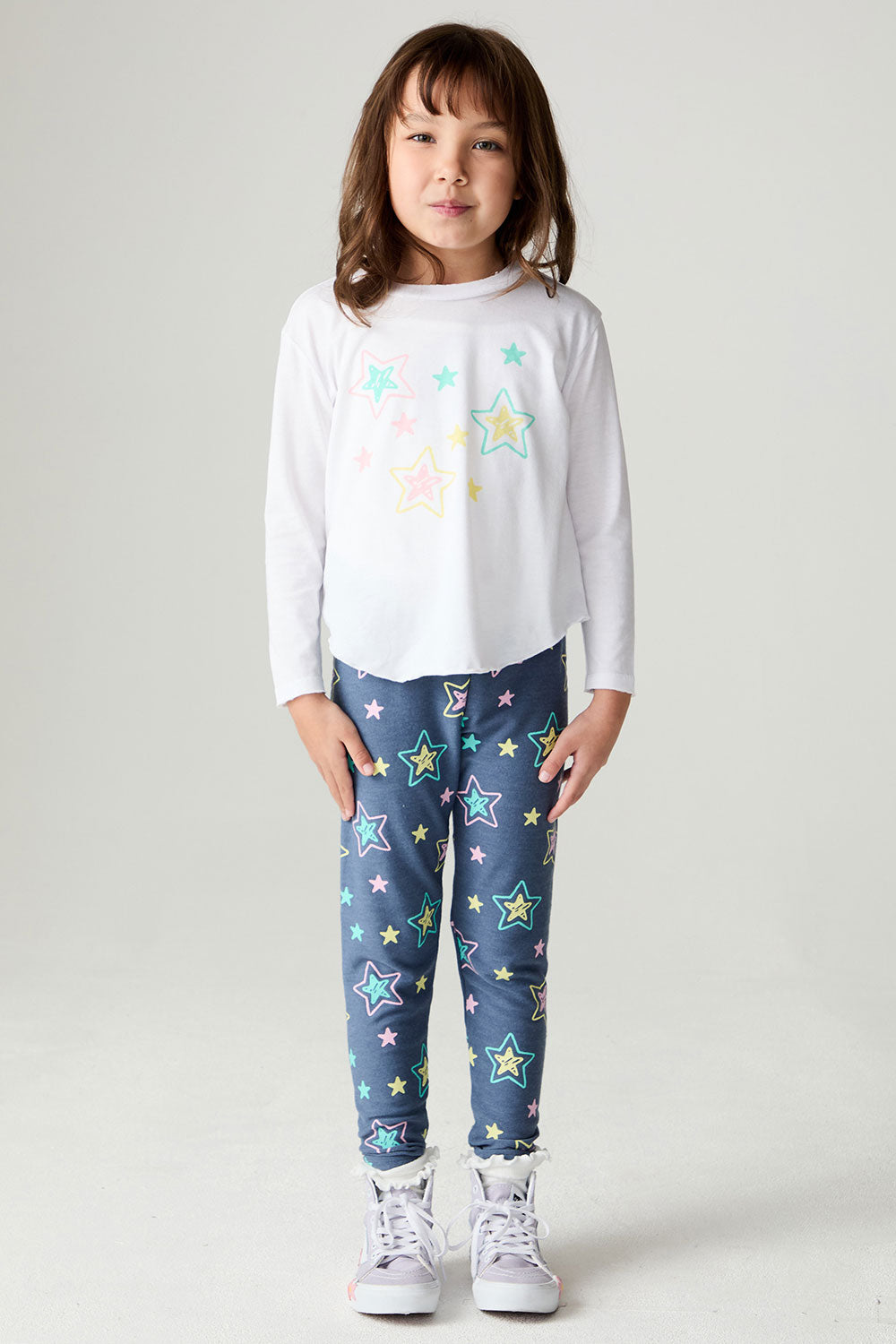 A full body front view of a girl wearing the Chaser Under The Stars Girls Tee on a neutral background