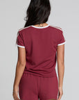Back view of a woman wearing the Chaser Urban Burnt Red Tee on a neutral background with shorts