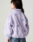 Back view of a girl wearing the Chaser Varsity Stars Girls Varsity Jacket on a neutral background with jeans