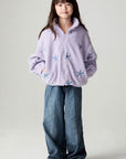 A full body front view of a girl wearing the Chaser Varsity Stars Girls Varsity Jacket on a neutral background