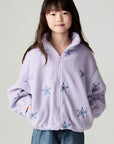 Front view of a girl wearing the Chaser Varsity Stars Girls Varsity Jacket on a neutral background looking at camera