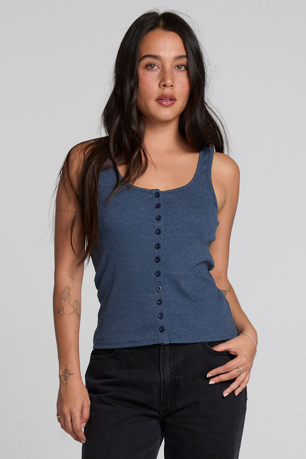 Front view of a woman wearing the Chaser Velora Dark Denim Tank on a neutral background 