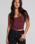 Front view of a woman wearing the Chaser Verze Brick Tank and high waisted jeans on a neutral background