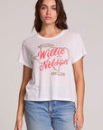 Front view of a woman wearing the Chaser Willie Nelson Fan Club Tee on a neutral background with arms at sides