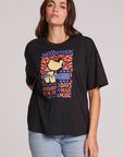 Front view of a woman wearing the Chaser  Woodstock Bird on Guitar Tee on a neutral background with bluejeans