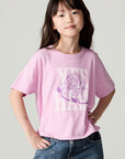 Front view of a girl wearing the Chaser Yee Haw Girls Tee and jeans on a neutral background with hands on hips