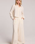 Woman wearing the Chaser Coconut Milk Campaniaa Trousers set on a neutral background 
