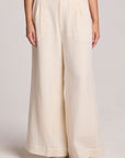 Front view of a woman wearing the Chaser Coconut Milk Campaniaa Trousers on a neutral background 
