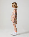 Full body side view of a boy wearing the Chaser Construction Days Tee on a neutral background