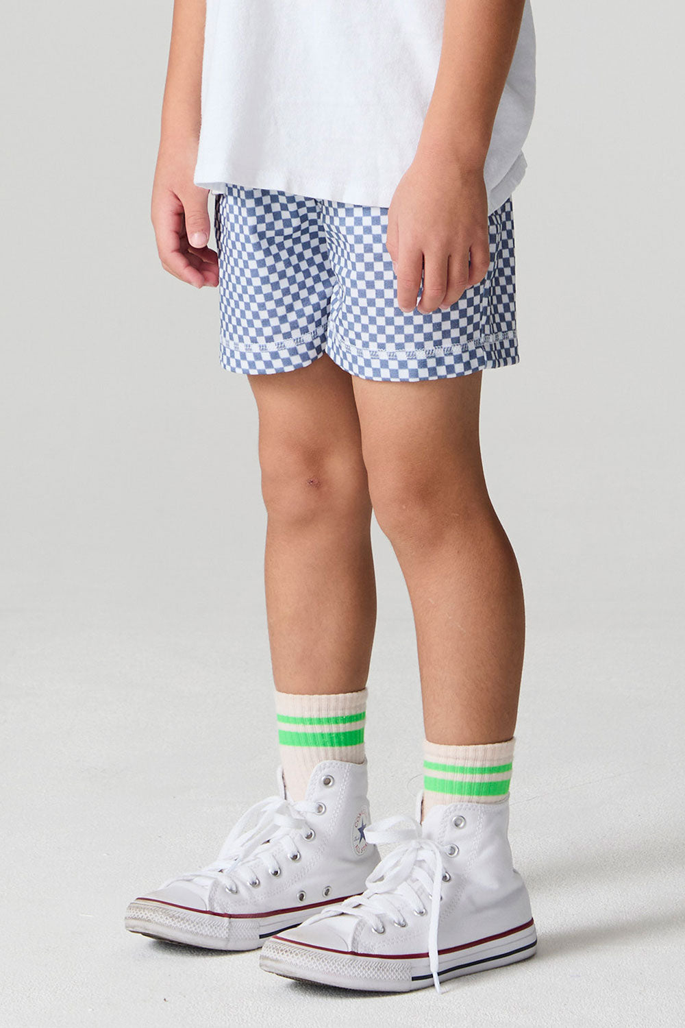 Side angle view of a boy wearing the Chaser  Cozy Beach Short on a neutral background