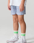Side angle view of a boy wearing the Chaser  Cozy Beach Short on a neutral background