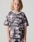 Front view of a boy wearing the Chaser Dusty Camo Tee  on a neutral background