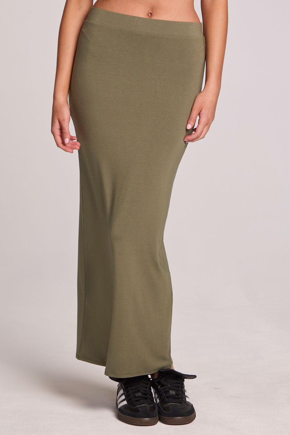 Front view of a woman wearing the Chaser Eloyse Forager Green Skirt on a neutral background
