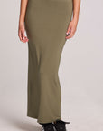 Front view of a woman wearing the Chaser Eloyse Forager Green Skirt on a neutral background