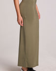 Side view of a woman wearing the Chaser Eloyse Forager Green Skirt on a neutral background with arms at sides 