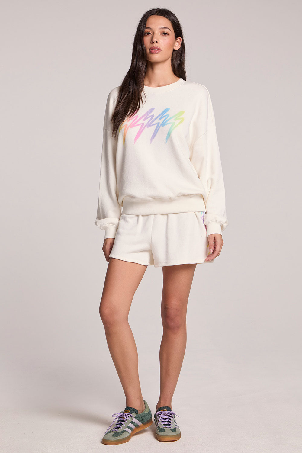 Full body front view of a woman wearing the Chaser Gradient Bolt Shorts on a neutral background