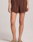 A full body front view of a woman wearing the Chaser Kahlua Harper Shorts and clogs on a neutral background