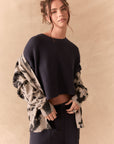 Full body view of model in black tie dye hoodie
