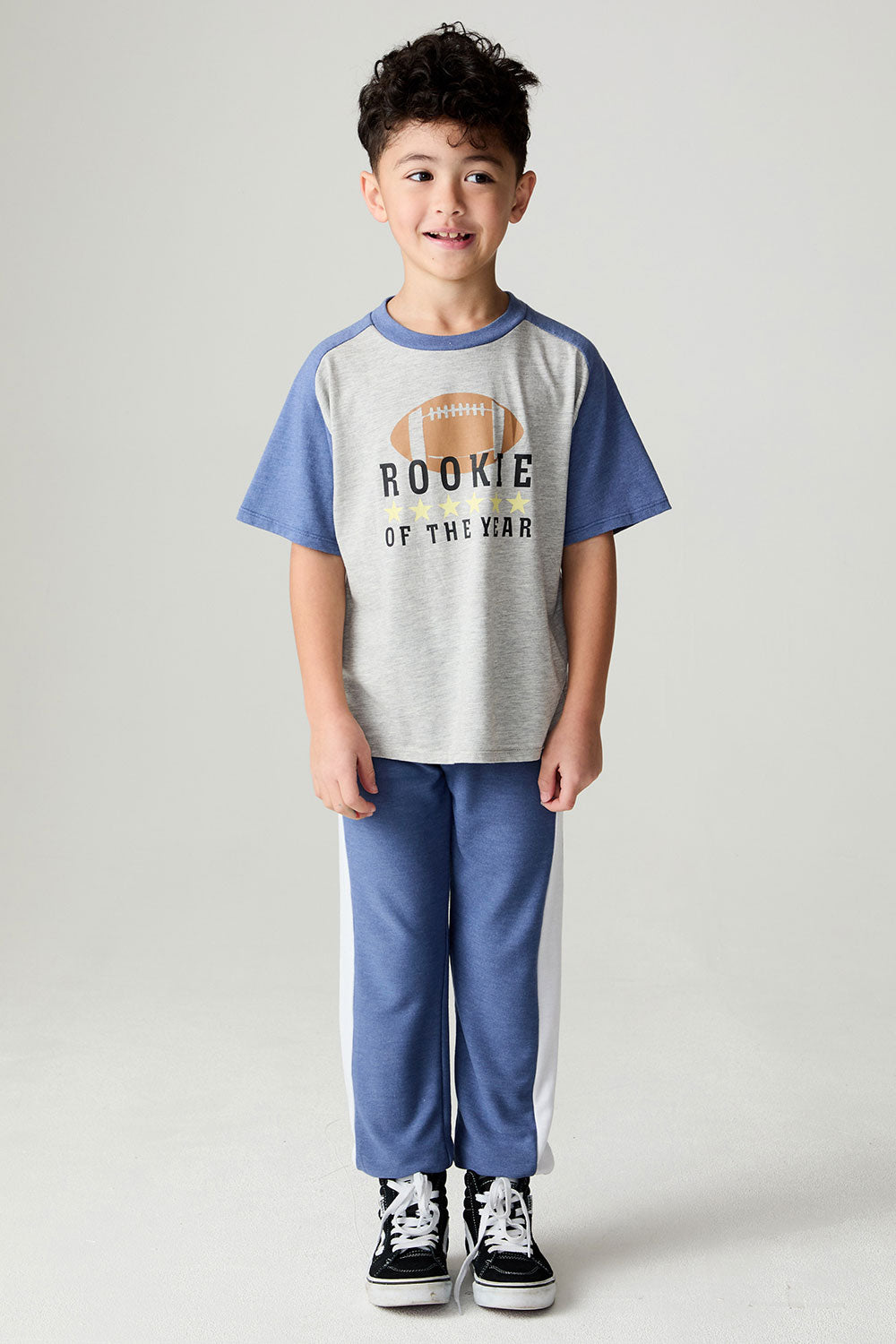 Full body front view of a boy wearing the Chaser Lounge Pants Boys Shamu Jogger on a neutral background with Rookie tee shirt