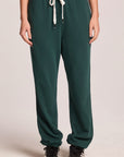 Front view of a woman wearing the Chaser   Manhattan Pine Joggers on a neutral background with hands at her sides

