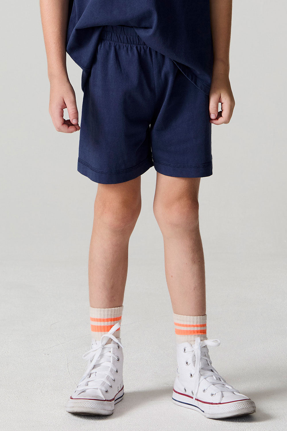 Front view of a boy wearing the Chaser Multi Bolt Shorts on a neutral background