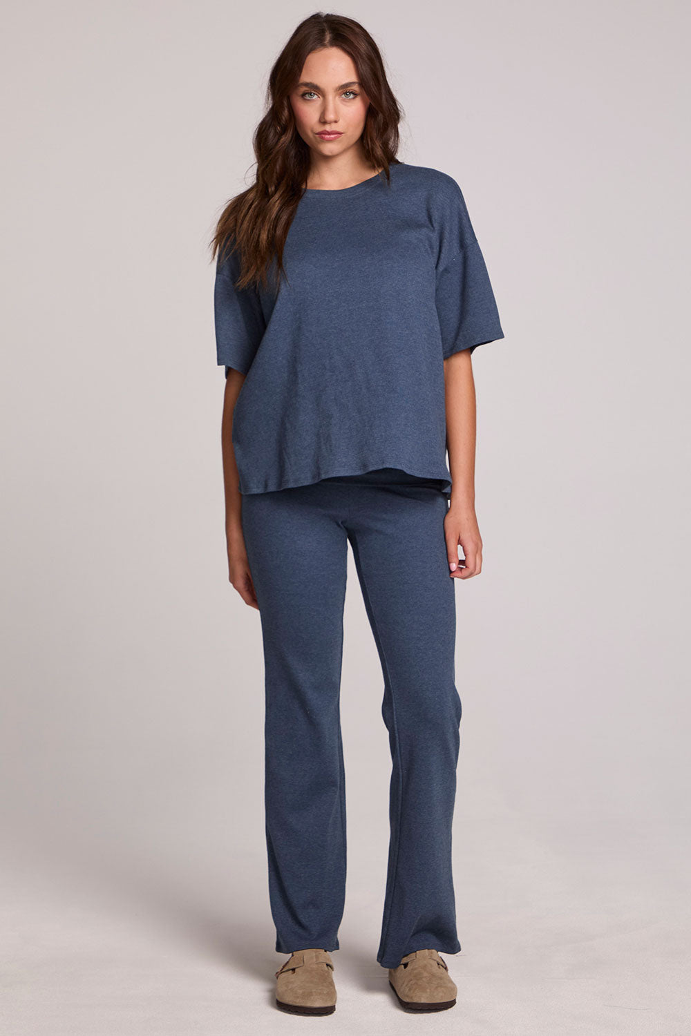 A full body front view of a woman wearing the Chaser Noorh Dark Denim Pants