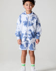 Full body front view of a boy wearing the Chaser Paxton Mistel Tie Dye Zip Up Hoodie on a neutral background
