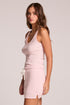 Side view of a woman wearing the Chaser  Prescot Pink Salt Tank Top and pink skort on a neutral background