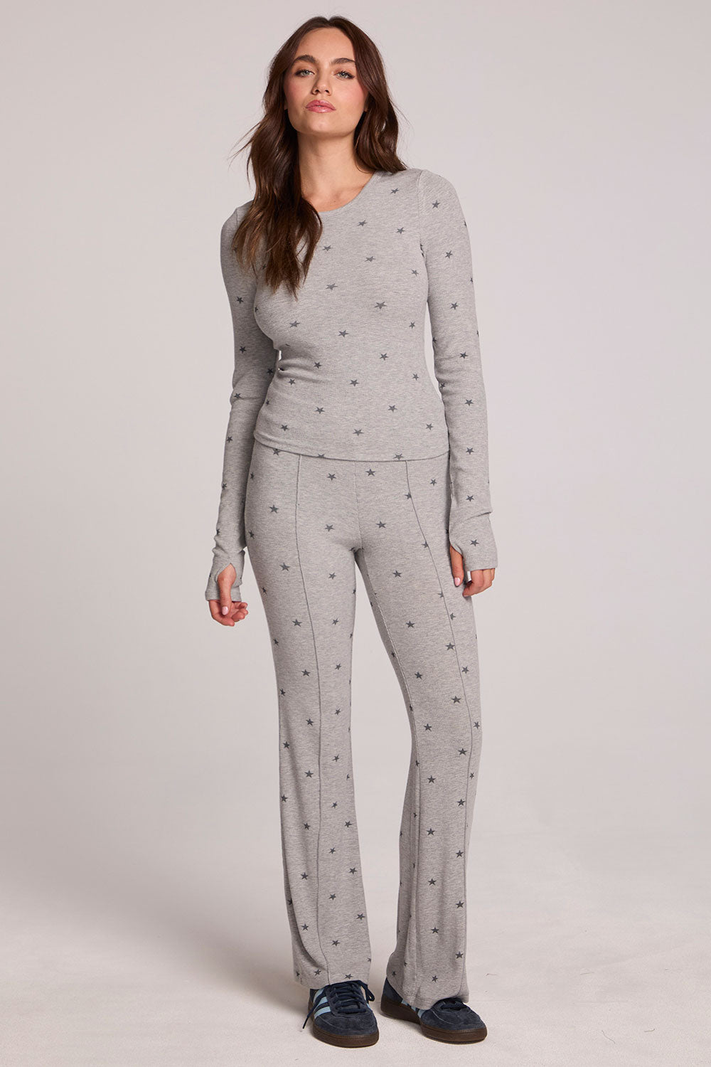 A full body front view of a woman wearing the Chaser Rhose Light Heather Grey Pants on a neutral background